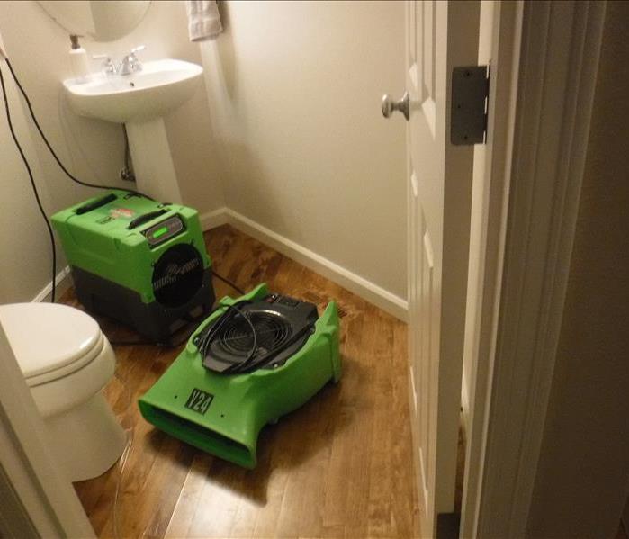 Sink, toilet, hard wood flooring and green equipment