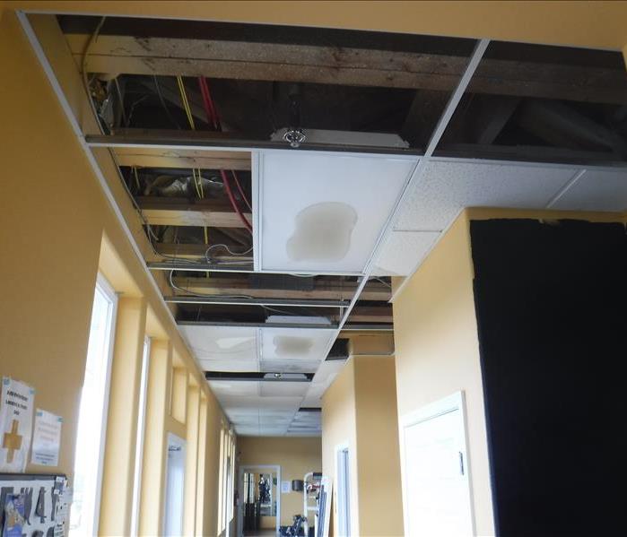 Hallway with ceiling tiles water affected