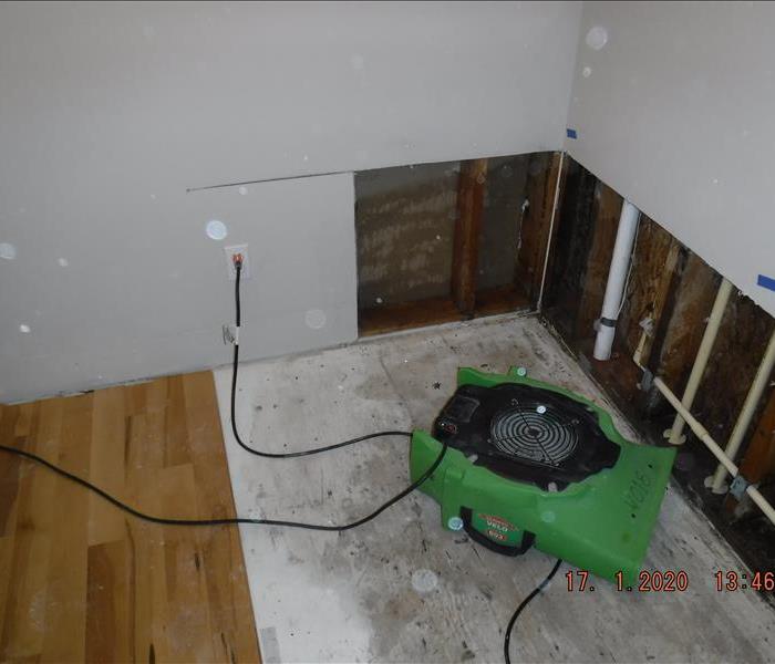 Removed wood flooring, green piece of equipment